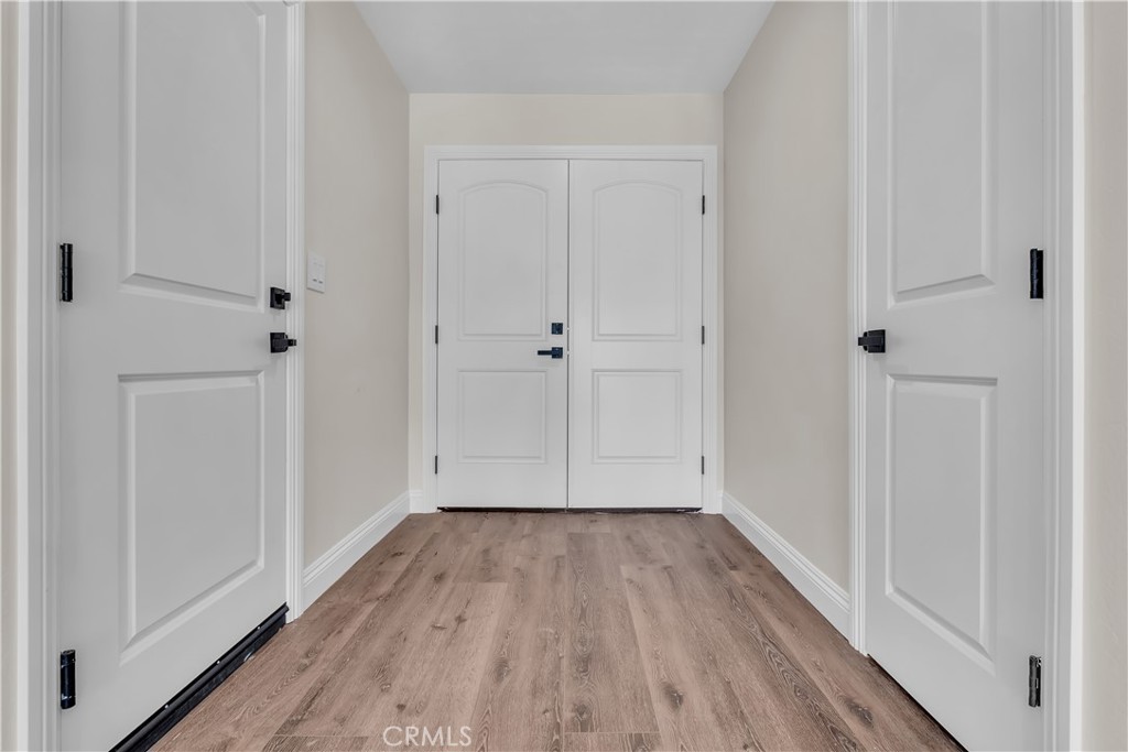 12524 Chanute Street Pacoima, CA 91331 - Photo 17 of 47 a view of a hallway with wooden floor