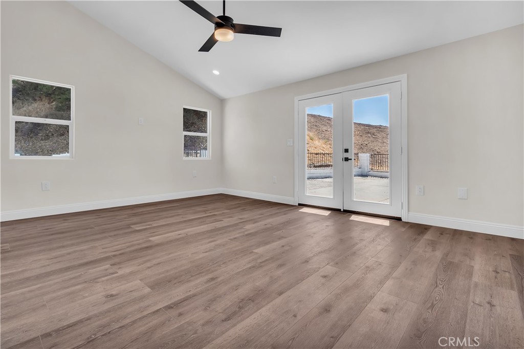 12524 Chanute Street Pacoima, CA 91331 - Photo 20 of 47 a view of an empty room with wooden floor and a window