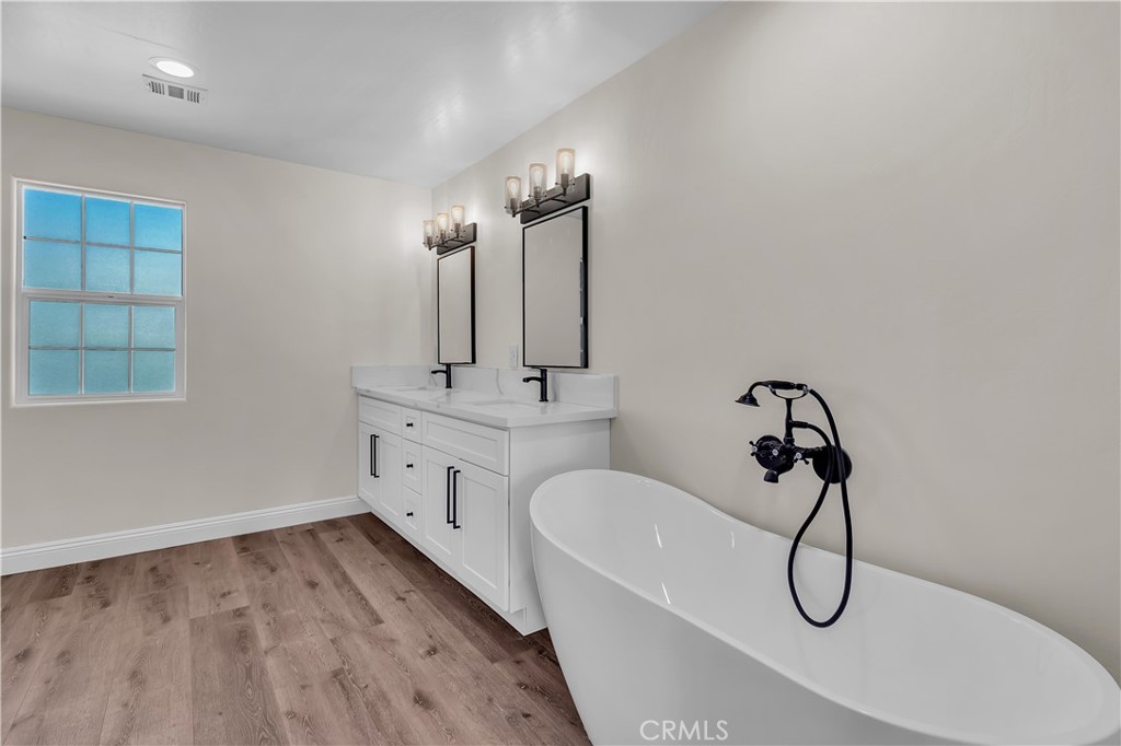 12524 Chanute Street Pacoima, CA 91331 - Photo 23 of 47 a bathroom with a granite countertop sink a toilet and shower