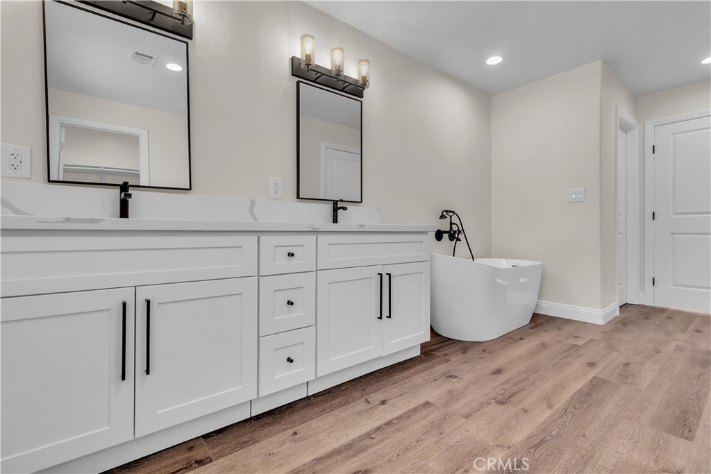 12524 Chanute Street Pacoima, CA 91331 - Photo 24 of 47 a spacious bathroom with double vanity sink a mirror and bathtub