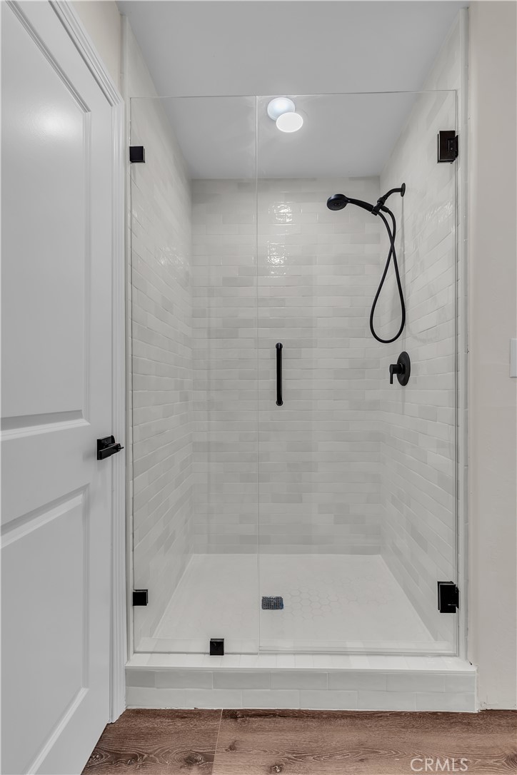 12524 Chanute Street Pacoima, CA 91331 - Photo 25 of 47 a bathroom with a bath tub with a glass door shower