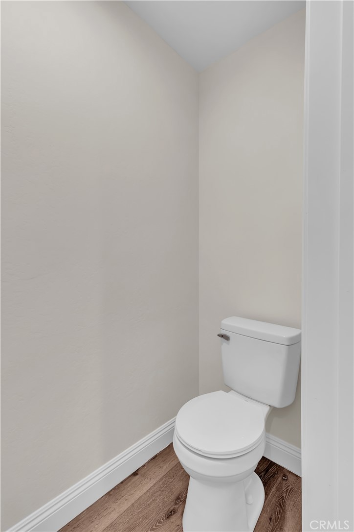 12524 Chanute Street Pacoima, CA 91331 - Photo 26 of 47 a white toilet sitting next to a white wall