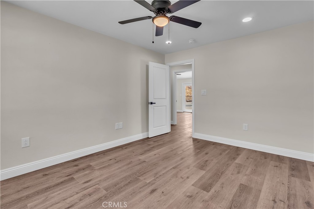 12524 Chanute Street Pacoima, CA 91331 - Photo 29 of 47 wooden floor in an empty room with a ceiling fan