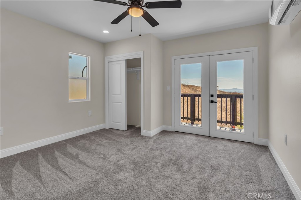 12524 Chanute Street Pacoima, CA 91331 - Photo 32 of 47 an empty room with chandelier fan and windows