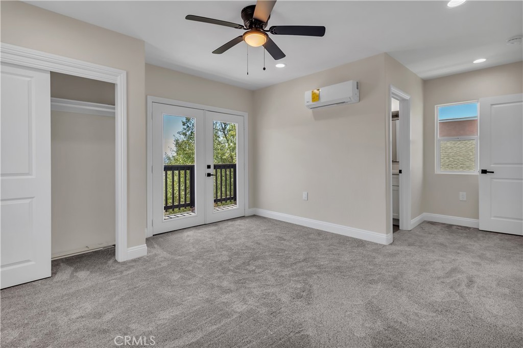 12524 Chanute Street Pacoima, CA 91331 - Photo 33 of 47 an empty room with chandelier fan and windows