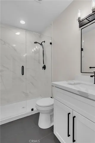 a bathroom with a shower a toilet and a sink