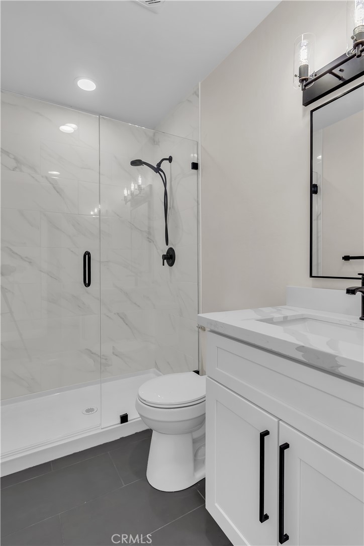 12524 Chanute Street Pacoima, CA 91331 - Photo 34 of 47 a bathroom with a shower a toilet and a sink