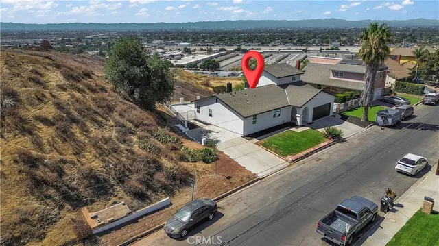 an aerial view of a house with a yard
