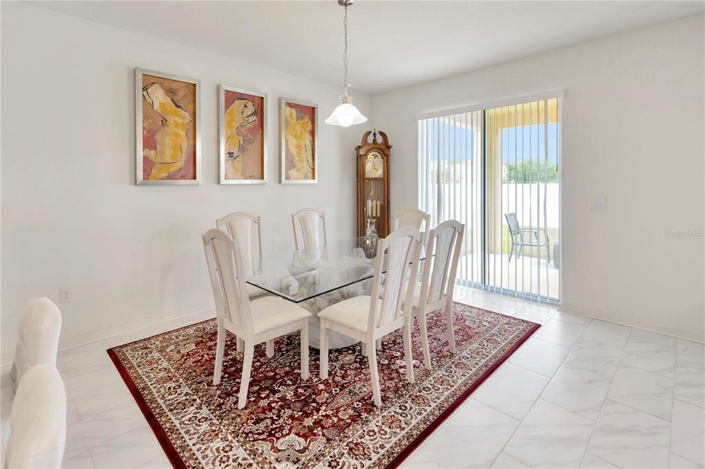 11530 Brighton Knoll Loop Riverview, FL 33579 - Photo 15 of 64 a view of a dining room with furniture wooden floor and a chandelier
