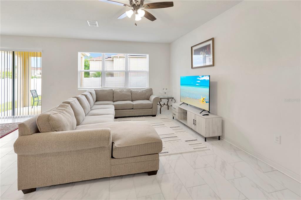 11530 Brighton Knoll Loop Riverview, FL 33579 - Photo 18 of 64 a living room with furniture and a flat screen tv