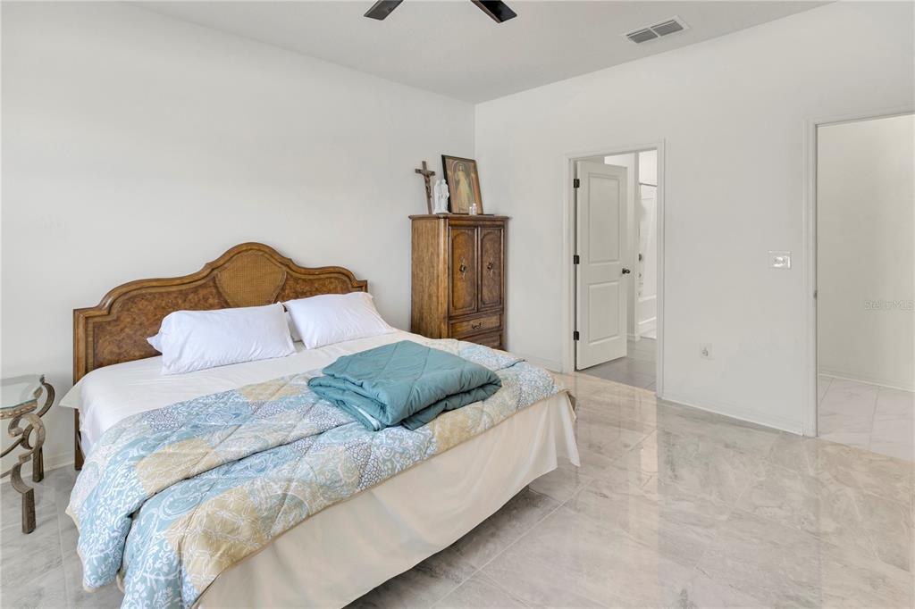 11530 Brighton Knoll Loop Riverview, FL 33579 - Photo 20 of 64 a bedroom with a bed and painting on the wall