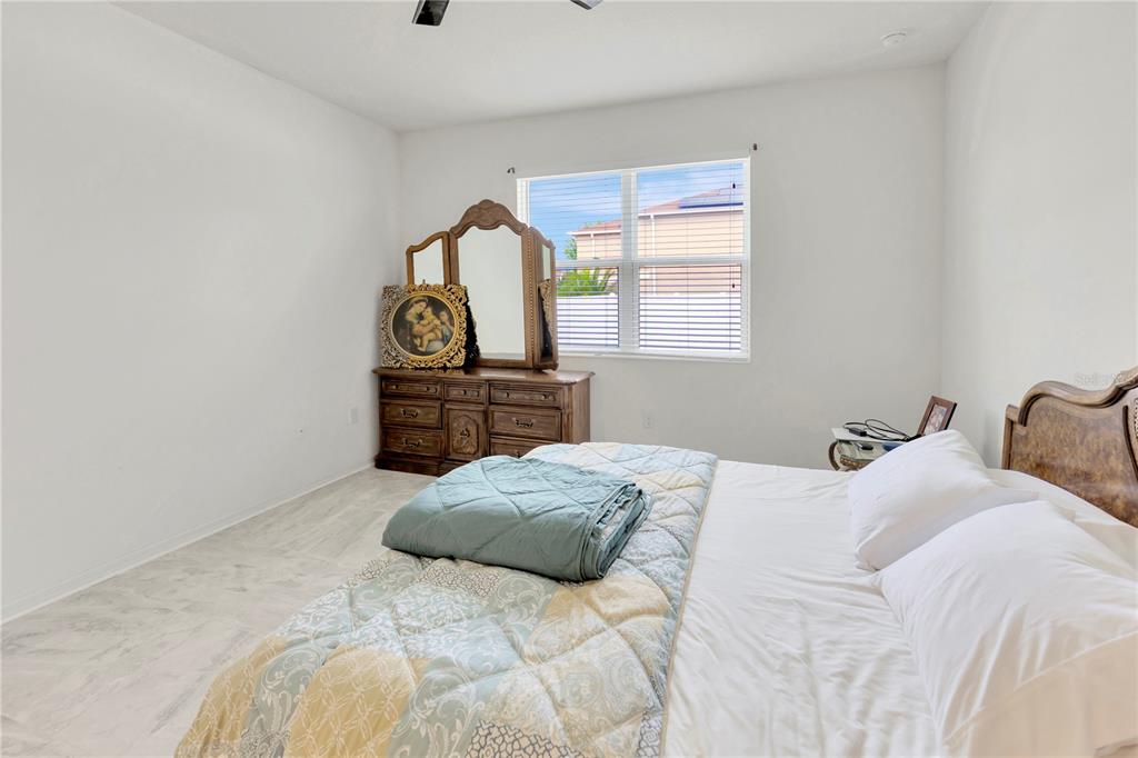 11530 Brighton Knoll Loop Riverview, FL 33579 - Photo 22 of 64 a bedroom with a bed and a dresser