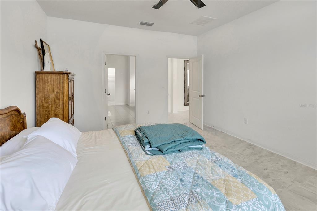 11530 Brighton Knoll Loop Riverview, FL 33579 - Photo 23 of 64 a bedroom with a bed and a painting on the wall