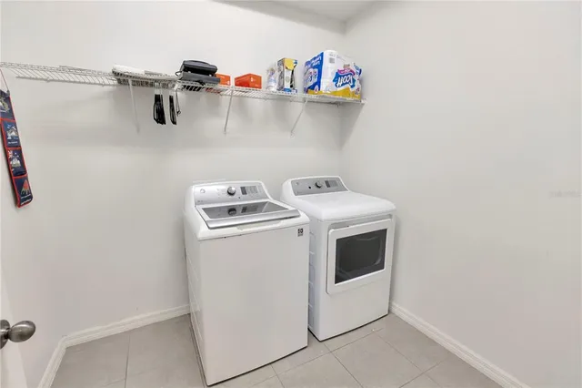 a utility room with a sink a vanity and a mirror