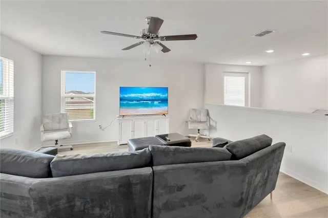 a bedroom with a bed and a potted plant