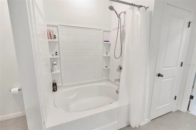 a bedroom with a large bed and a flat screen tv