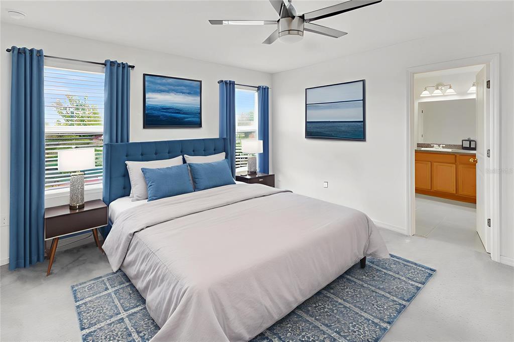 11530 Brighton Knoll Loop Riverview, FL 33579 - Photo 33 of 64 a bedroom with a large bed and a chandelier