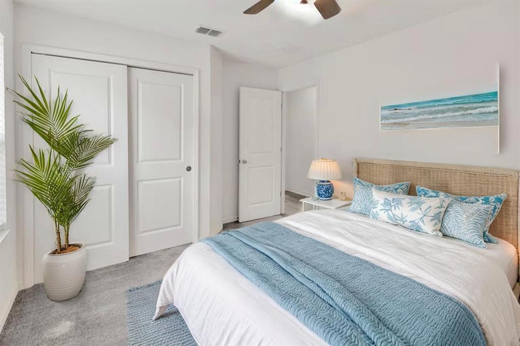 11530 Brighton Knoll Loop Riverview, FL 33579 - Photo 34 of 64 a bedroom with a bed and a potted plant