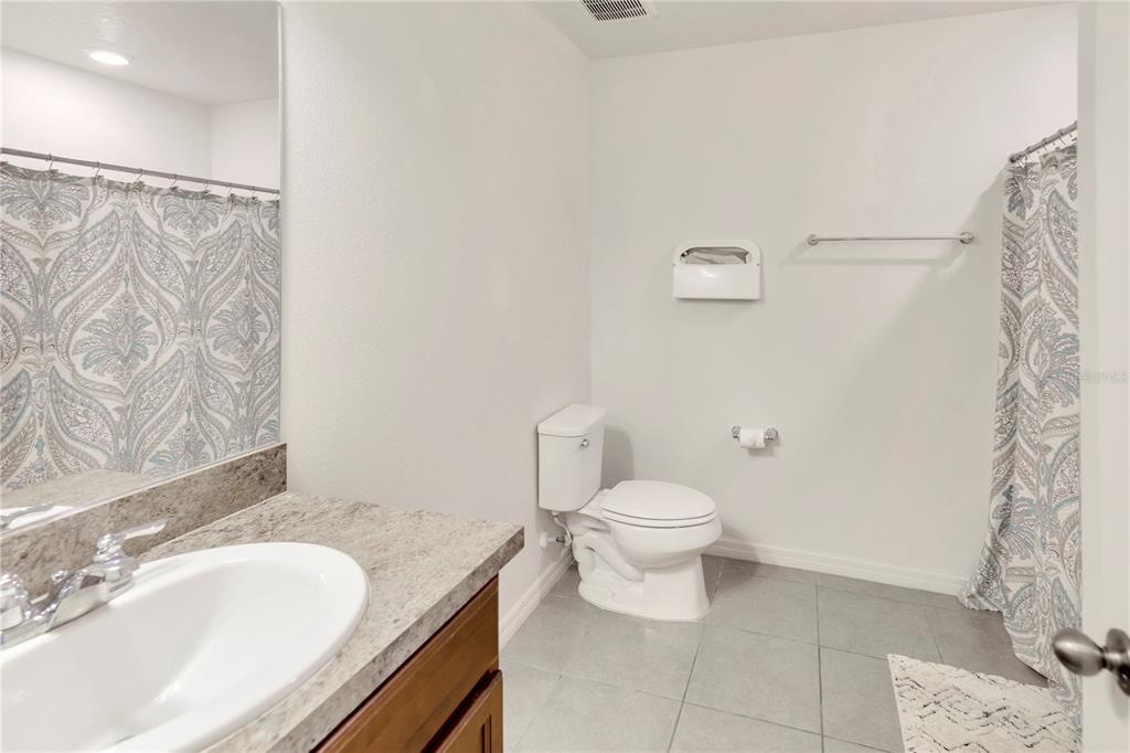 11530 Brighton Knoll Loop Riverview, FL 33579 - Photo 36 of 64 a bathroom with a granite countertop sink a toilet and a mirror