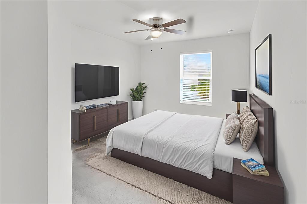 11530 Brighton Knoll Loop Riverview, FL 33579 - Photo 39 of 64 a bedroom with a large bed and a flat screen tv