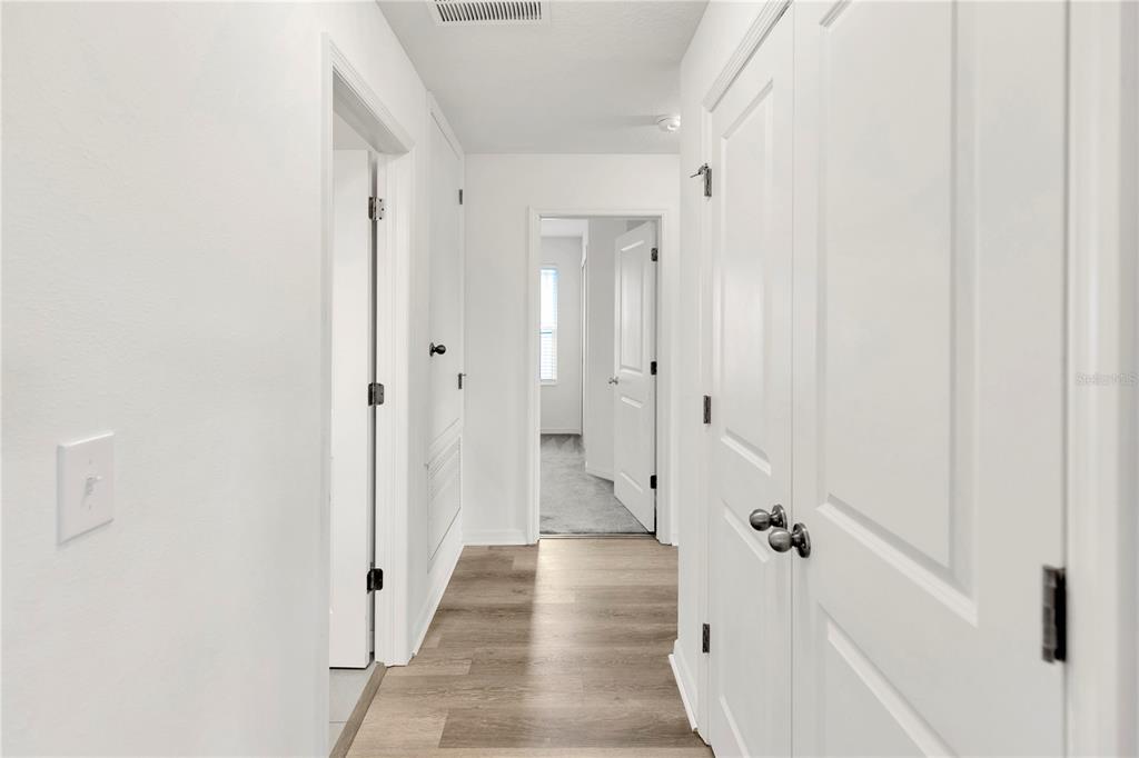 11530 Brighton Knoll Loop Riverview, FL 33579 - Photo 40 of 64 a view of a hallway with a closet and wooden floor
