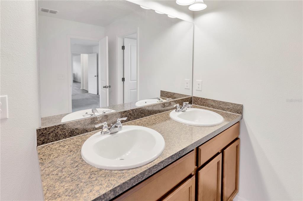 11530 Brighton Knoll Loop Riverview, FL 33579 - Photo 45 of 64 a bathroom with a granite countertop sink and a mirror