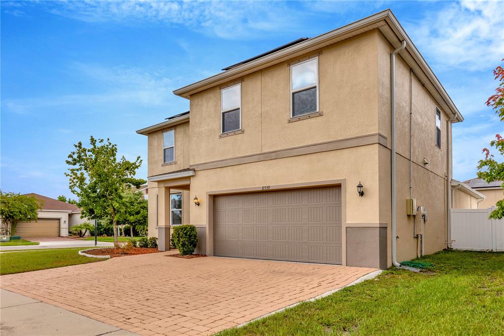 11530 Brighton Knoll Loop Riverview, FL 33579 - Photo 49 of 64 a front view of a house with a yard and garage