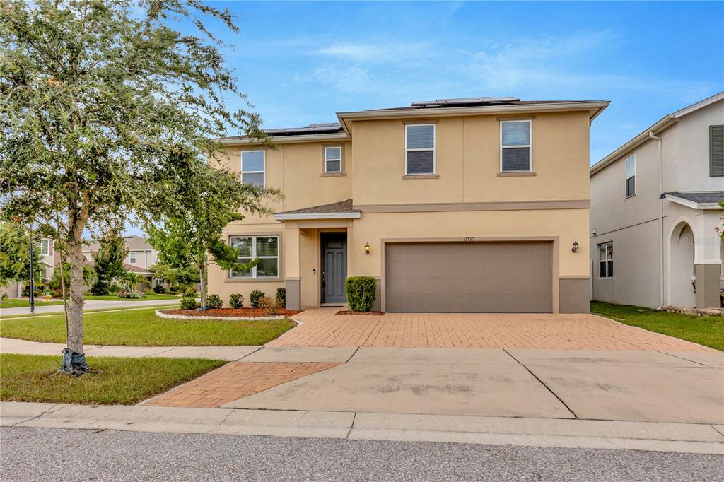 11530 Brighton Knoll Loop Riverview, FL 33579 - Photo 50 of 64 a front view of a house with a yard and garage