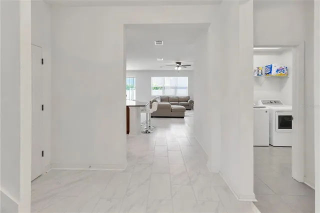 a view of a hallway with wooden floor and entryway