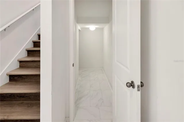 a kitchen with stainless steel appliances granite countertop a sink and stove top oven with wooden floor