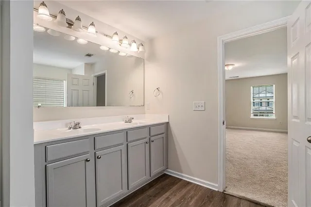 a white bath tub sitting in a bathroom next to a window