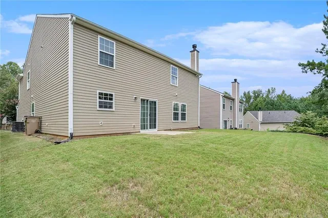 a front view of a house with a yard and a garage