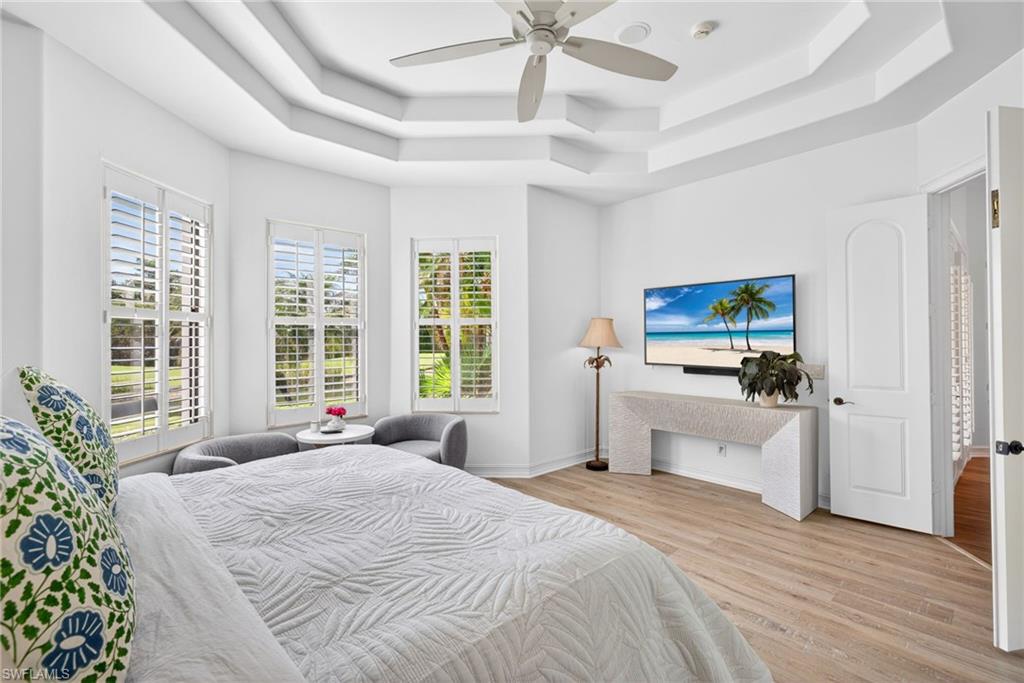 3296 Lookout Lane Naples, FL 34112 - Photo 14 of 39 a bedroom with a large bed and a tv