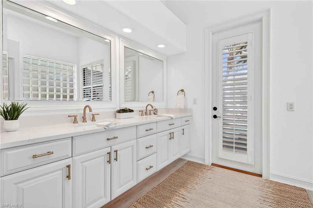 3296 Lookout Lane Naples, FL 34112 - Photo 17 of 39 a bathroom with double vanity sink a two mirror a window and glass door