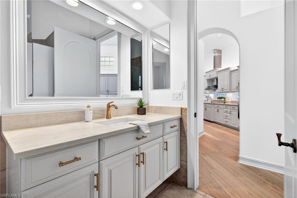 3296 Lookout Lane Naples, FL 34112 - Photo 21 of 39 a bathroom with a sink and a mirror