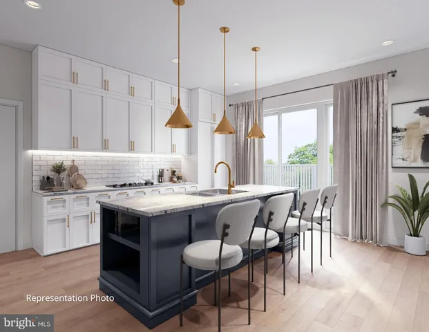 a kitchen with a stove a sink a kitchen island with a dining table and chairs
