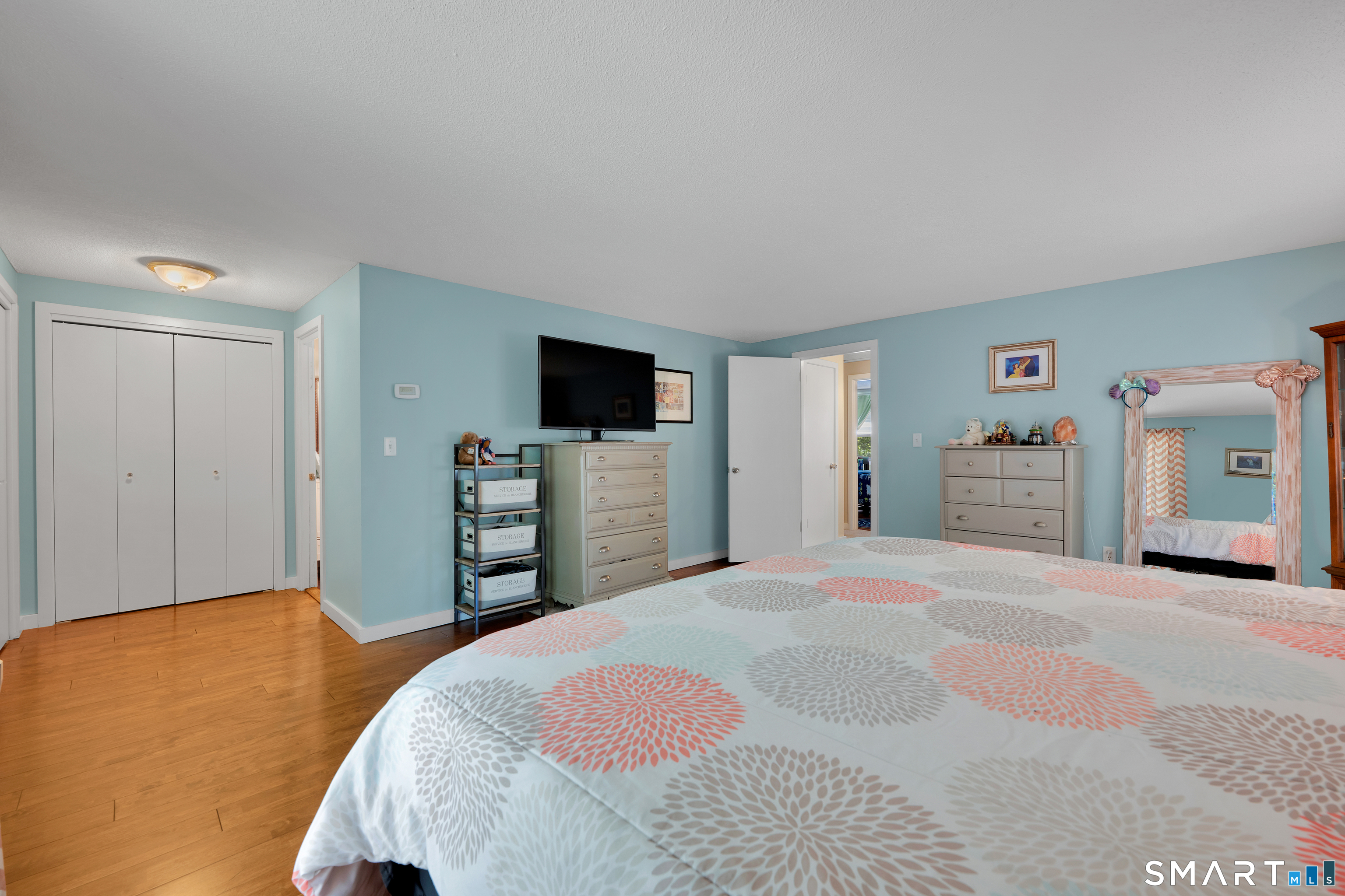 116 Canton Road Granby, CT 06035 - Photo 17 of 29 a bedroom with a bed and a flat tv screen on wall