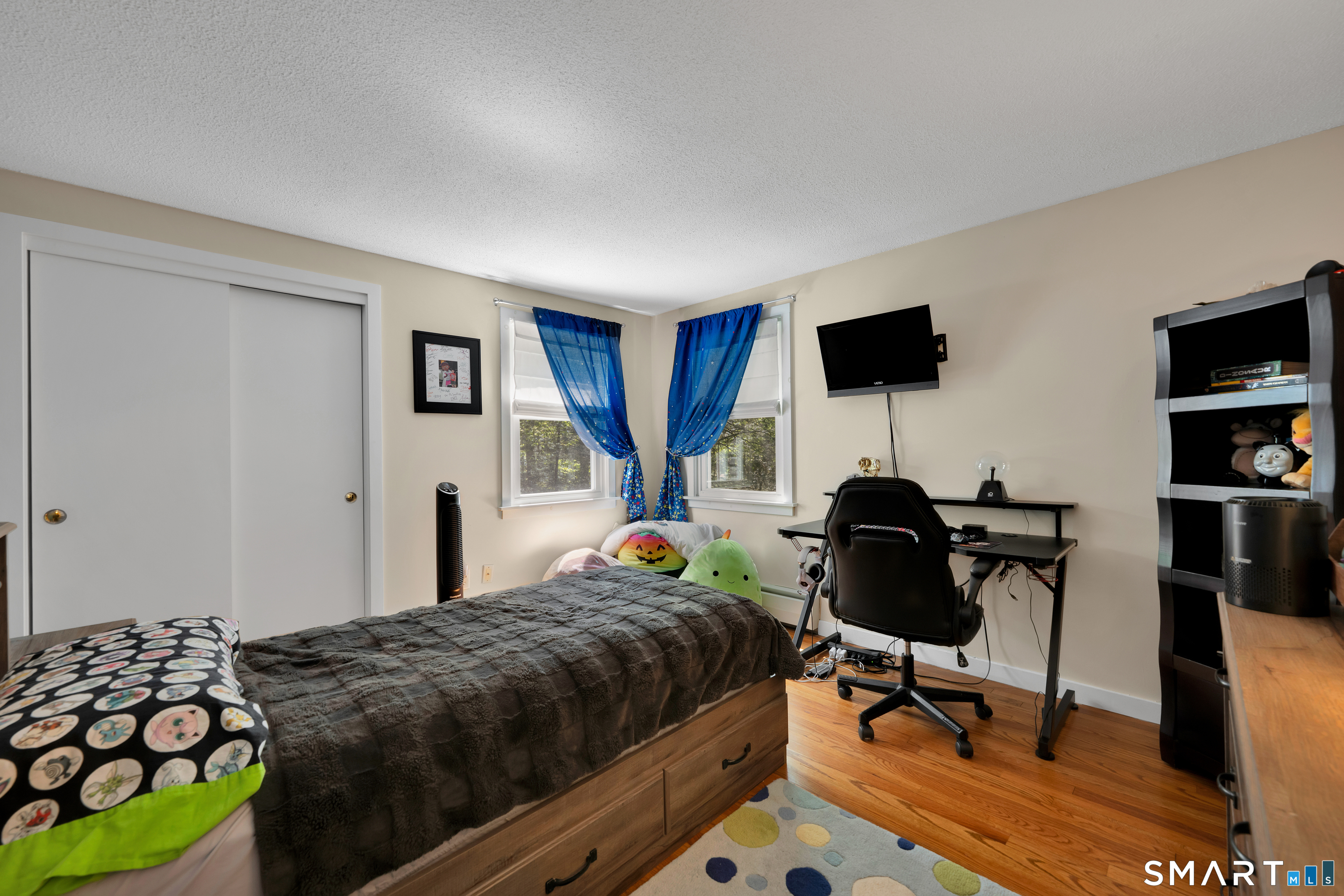 116 Canton Road Granby, CT 06035 - Photo 19 of 29 a bedroom with a bed and a flat screen tv