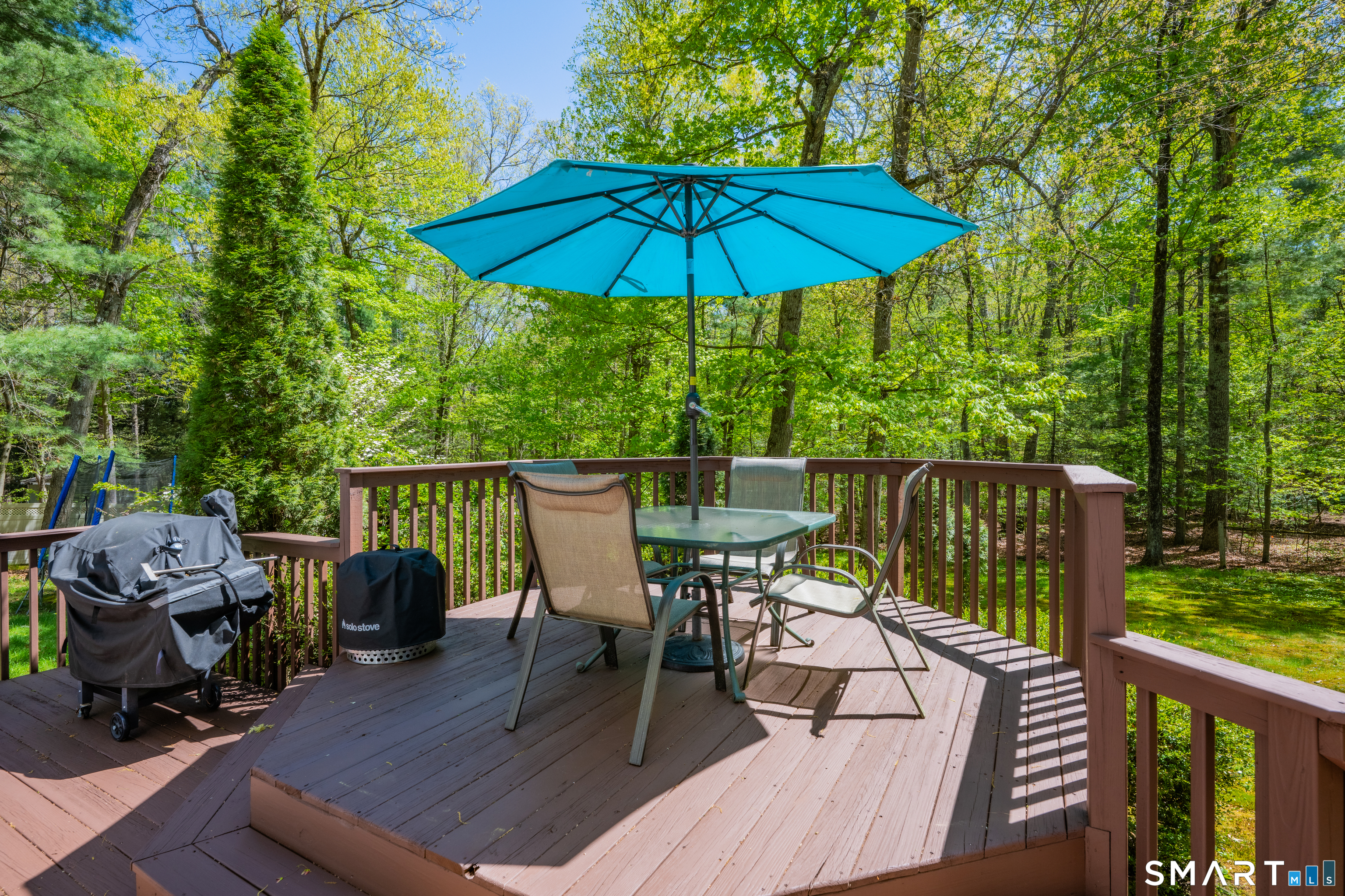 116 Canton Road Granby, CT 06035 - Photo 25 of 29 a view of deck with furniture and barbeque grill with wooden floor and fence