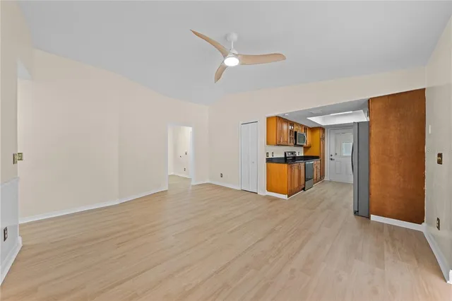 a view of an empty room with wooden floor