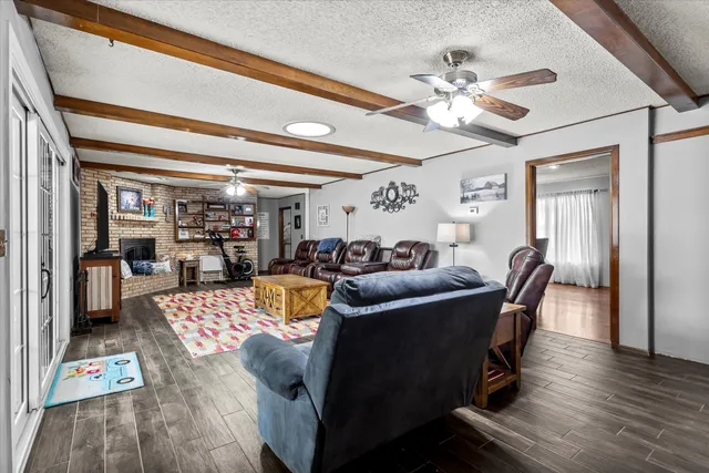 a dining room with furniture a chandelier and wooden floor
