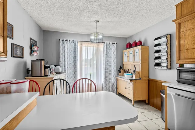 a view of a dining room with furniture and a window