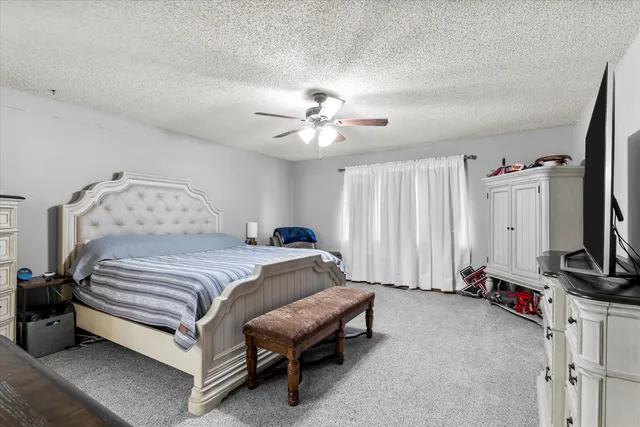 a bedroom with a bed and a flat screen tv in it