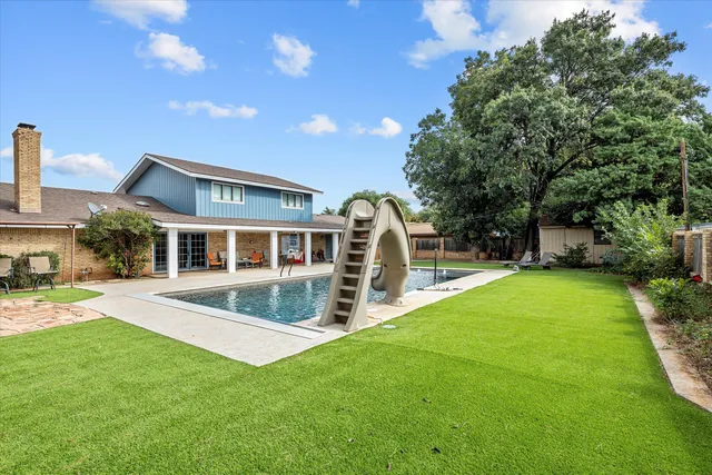 a front view of a house with a yard table and chairs
