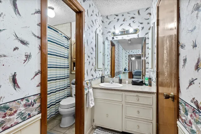 a kitchen with granite countertop a sink a stove and cabinets