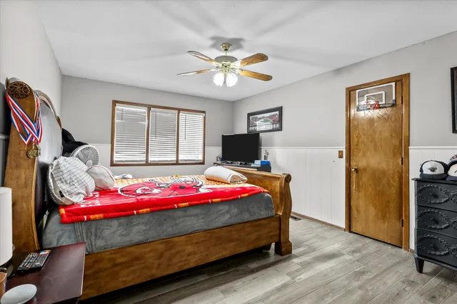 a bedroom with a bed and a chandelier
