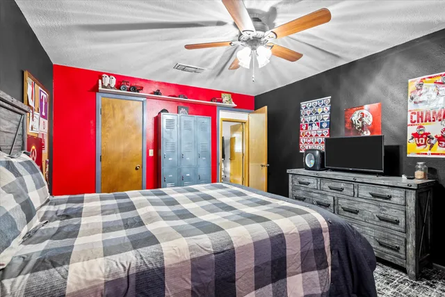 a bed sitting in a bedroom next to a window