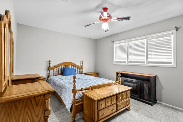 a bedroom with a bed and a flat screen tv with the dresser