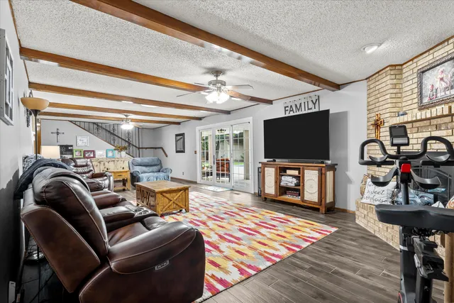 a living room with furniture a rug and a chandelier