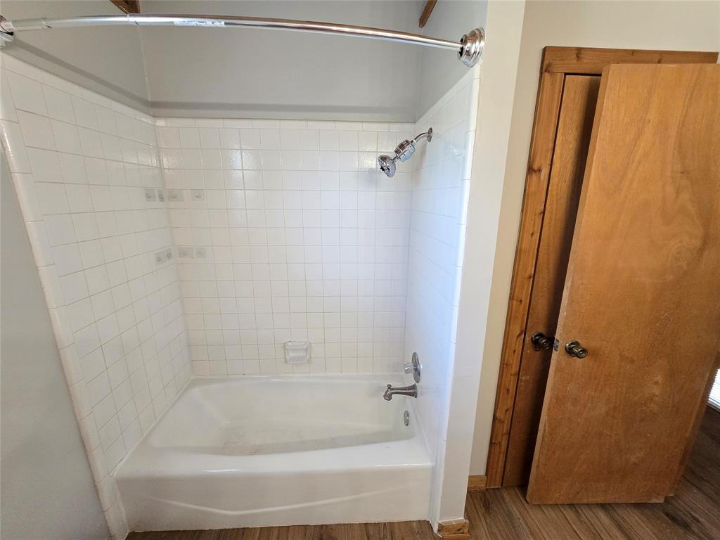 3505 Farmer Road Azle, TX 76020 - Photo 32 of 40 Tile shower surround and tub with a shower curtain rod already installed for your convenience.